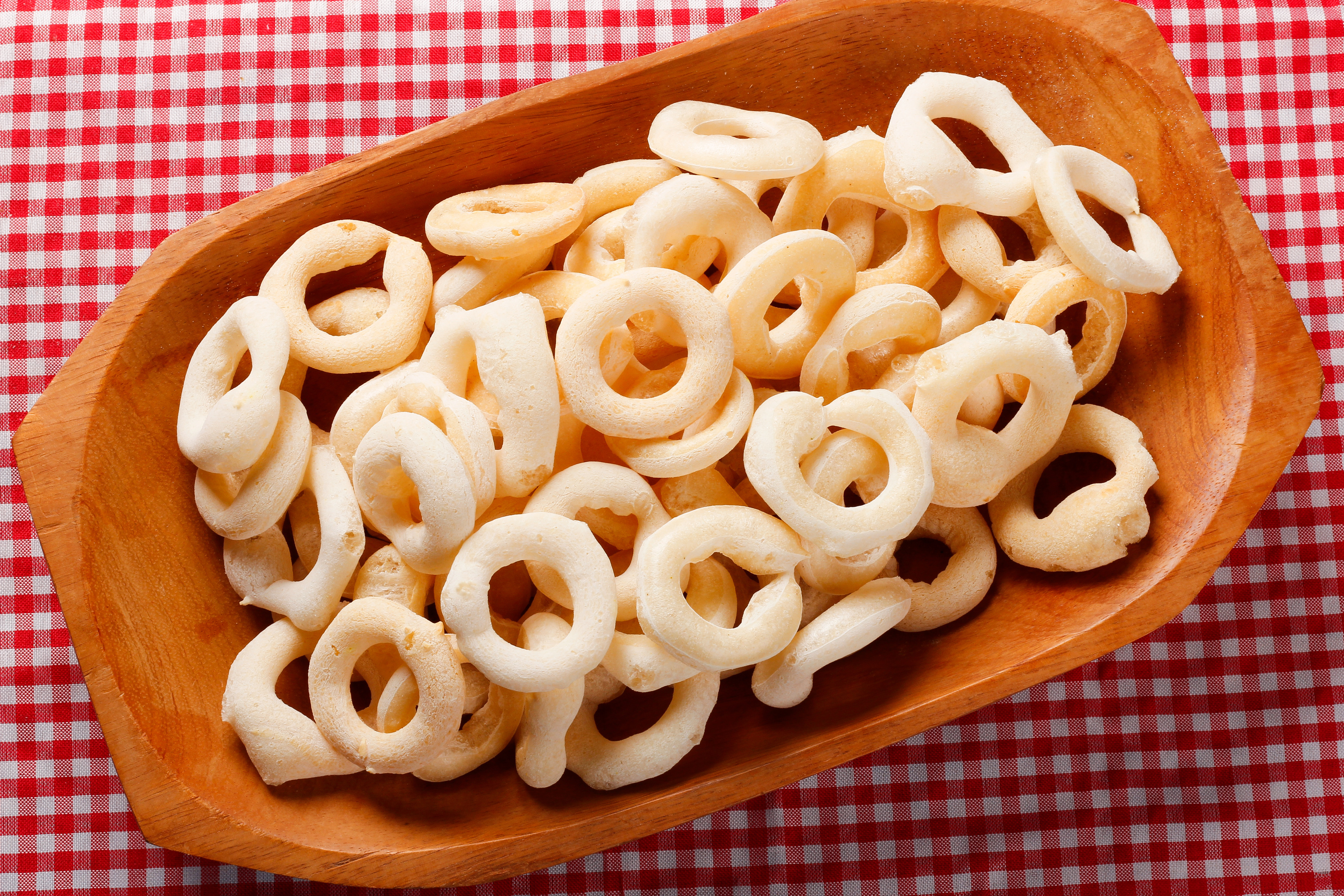 Traditional Brazilian starch biscuit, called polvilho biscuit in wooden bowl